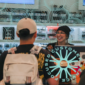 Interior view of our dispensary near Revere with the words Focused Customer Service, showing a customer talking to a staffer