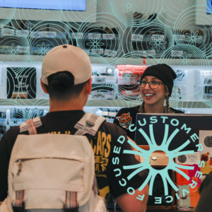 A staffer at our East Boston dispensary greets a customer in an image with Focused Customer Service superimposed.